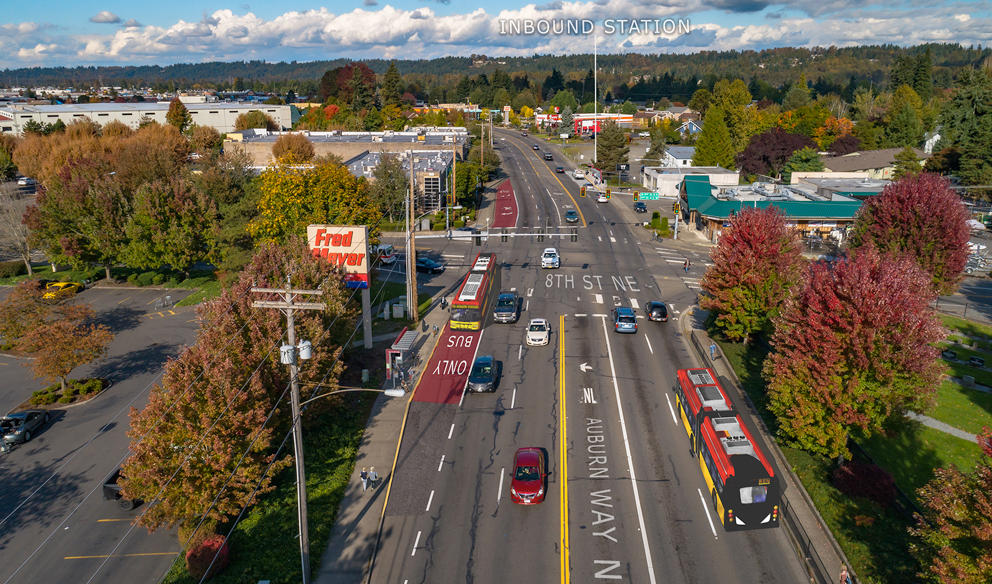 Aerial view of a RapidRide bus traveling in a red Business Access and Transit (BAT) lane next to mixed traffic near a bus stop on Auburn Way North at 8th Street NE.