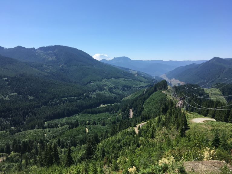 A diverse landscape of forests, roads, valleys and mountains